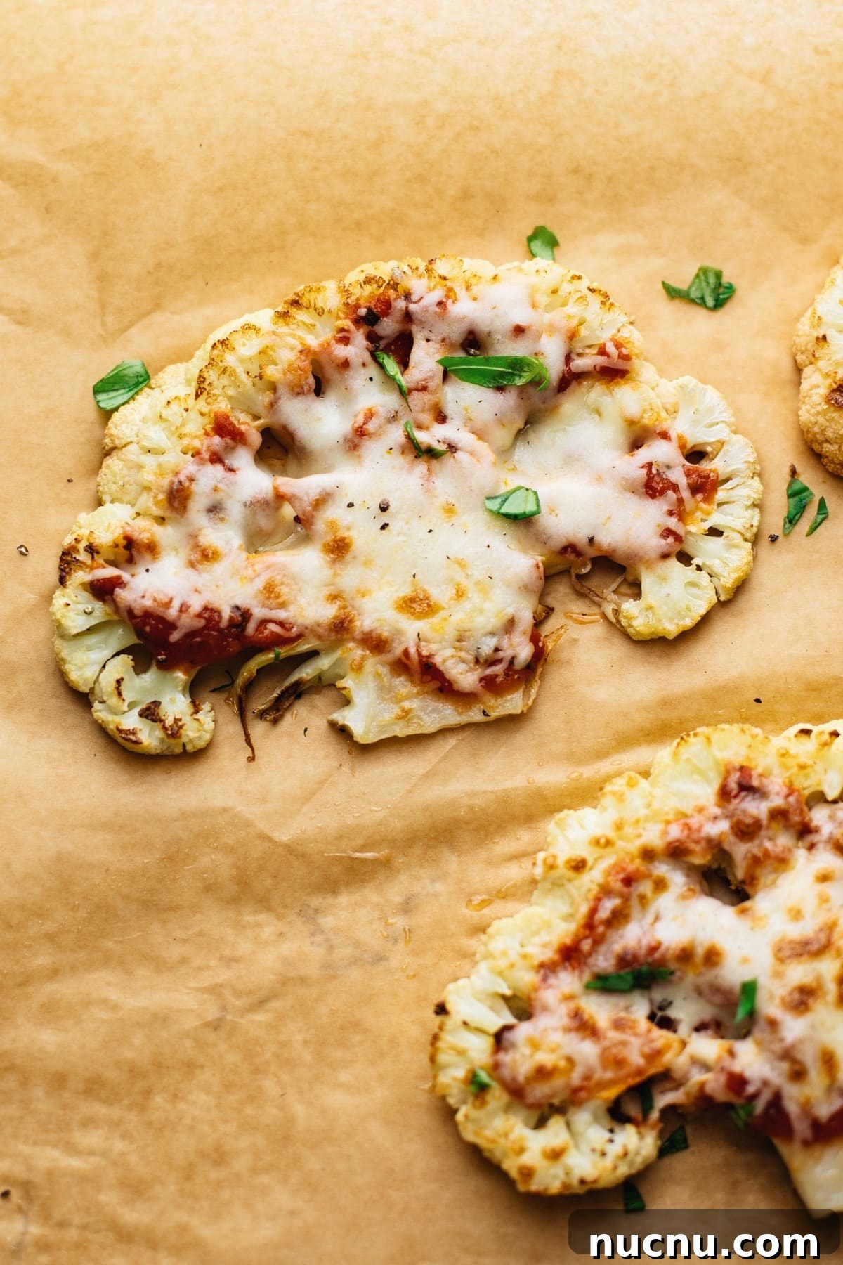 Cauliflower Steak Pizza: Crispy Low-Carb Veggie Pizza Recipe 6 Cauliflower steak pizzas arranged on brown parchment paper.