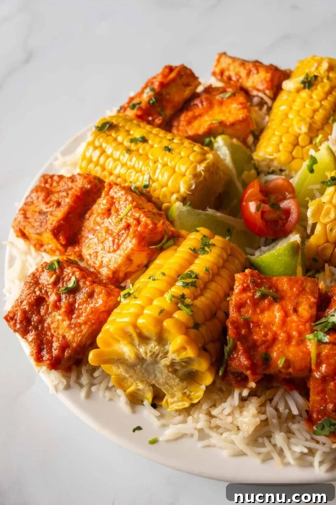 Fiery Peri-Peri Tofu Recipe for Bold, Smoky Flavor 2 front view of a plate of rice with spicy tofu and corn on the cob