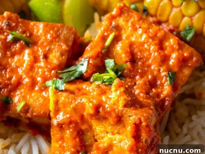 Close up of tofu with a thickened orange sauce