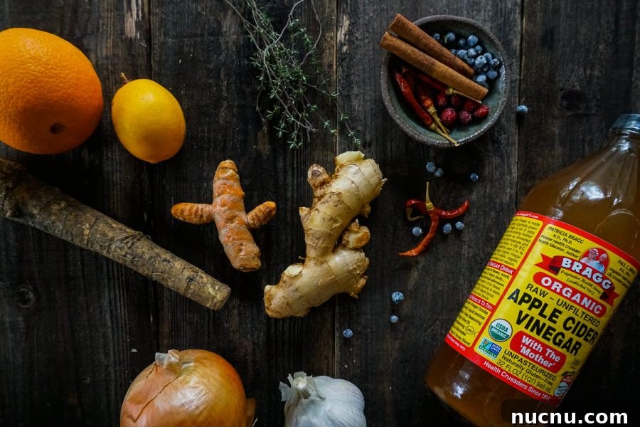 assorted ingredients to make fire cider arranged on a table