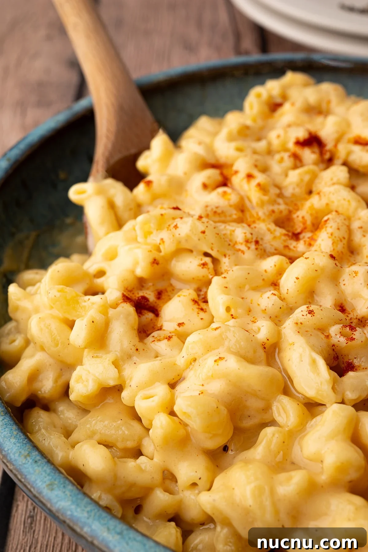 Creamy Stovetop Monterey Jack Mac and Cheese Recipe 2 A wooden spoon sits in a serving bowl full of creamy Texas Style macaroni and cheese.