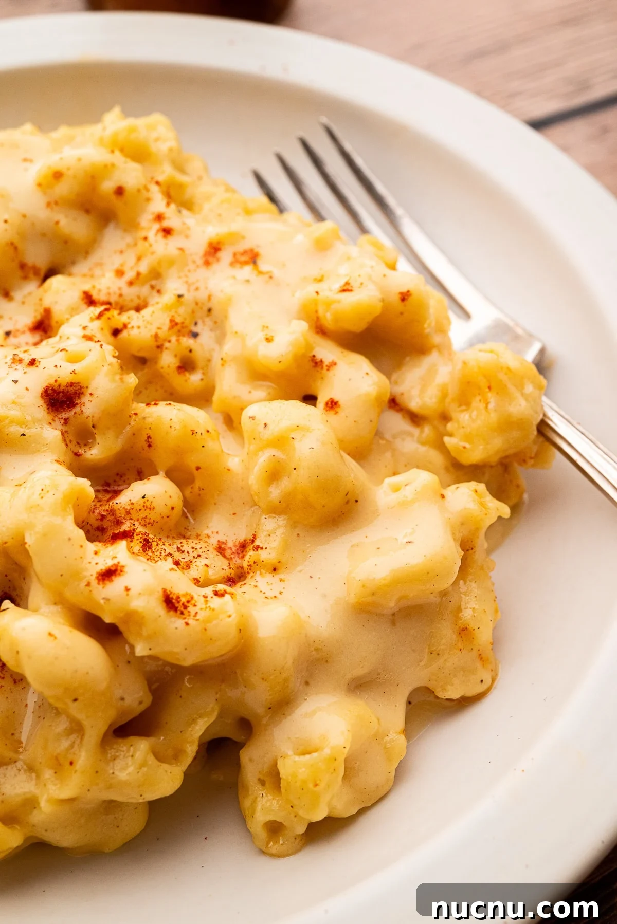 Creamy Stovetop Monterey Jack Mac and Cheese Recipe 4 Plate of cheesy macaroni and cheese with a fork, topped with smoked paprika.