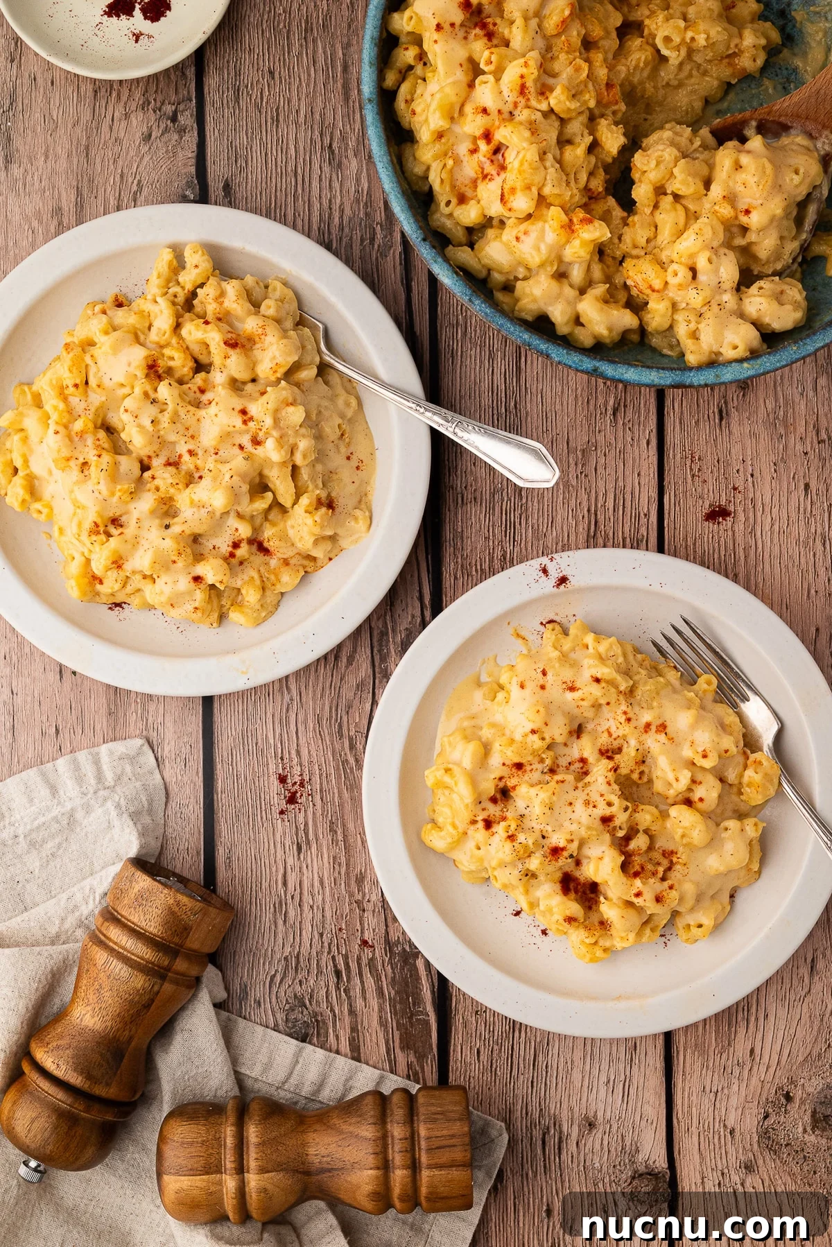 Creamy Stovetop Monterey Jack Mac and Cheese Recipe 8 3 bowls of Mac and cheese topped with paprika on a wood table
