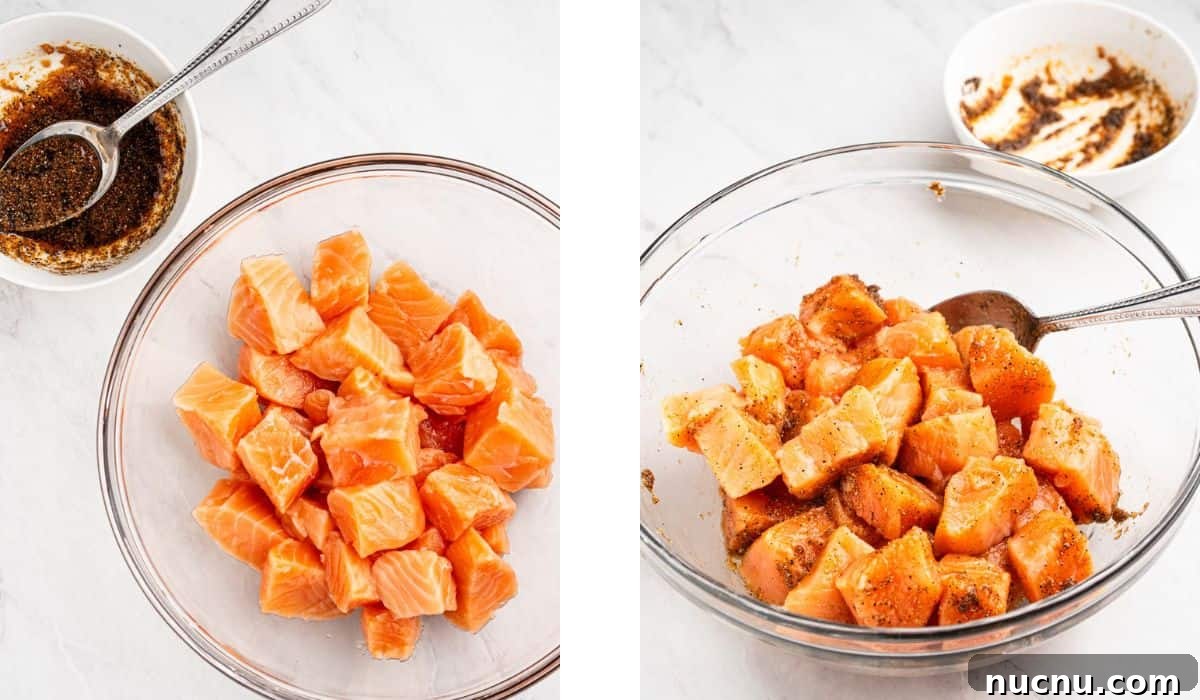Crispy Air Fryer Salmon Bites with Lemon Garlic Dip 5 Process of seasoning the salmon cubes in a mixing bowl.