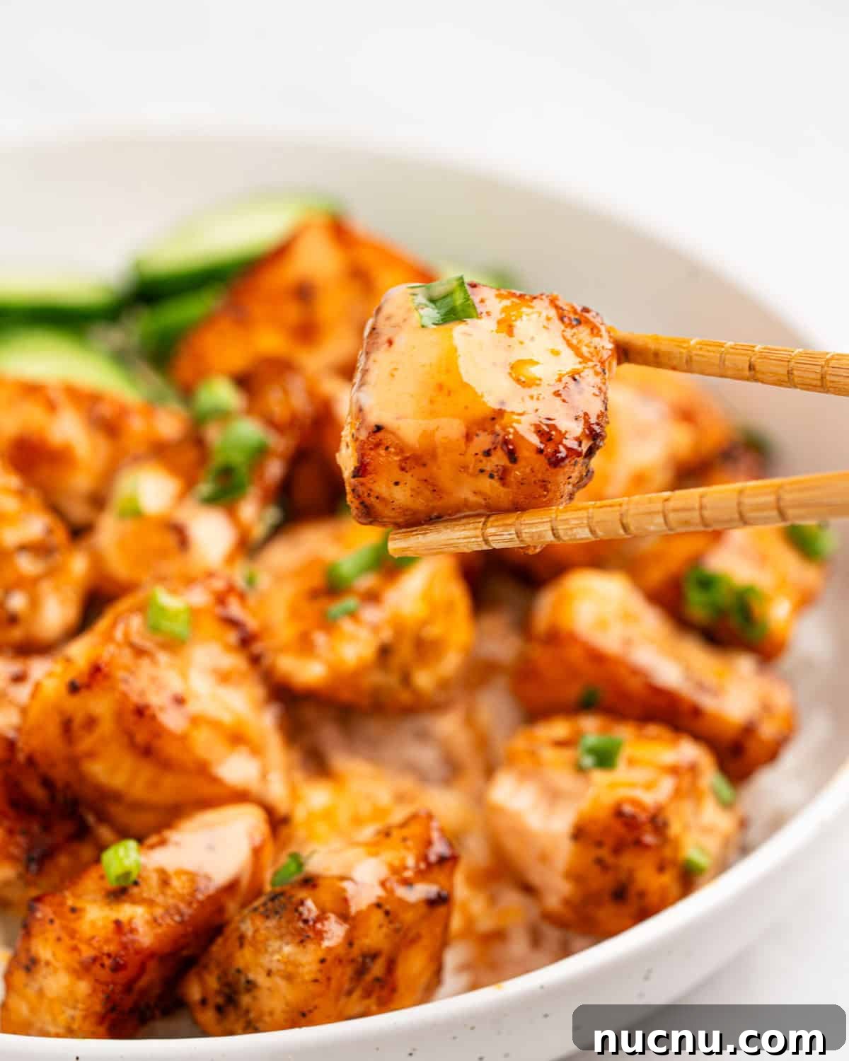 Crispy Air Fryer Salmon Bites with Lemon Garlic Dip 9 chopstick holding salmon bite.