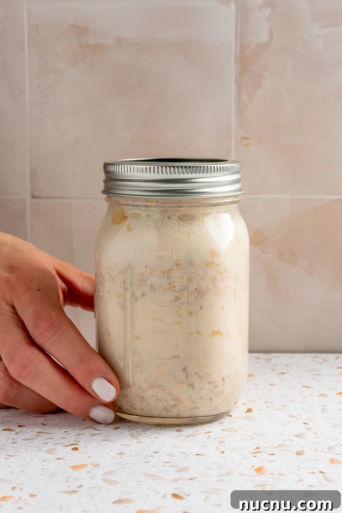 The ingredients in the mason jar have been shaken to combine.