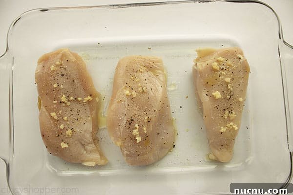 Juicy Air Fryer Chicken Breasts: Quick Crispy Recipe in 20 Minutes 9 Seasoned chicken breasts uncooked in a clear baking dish