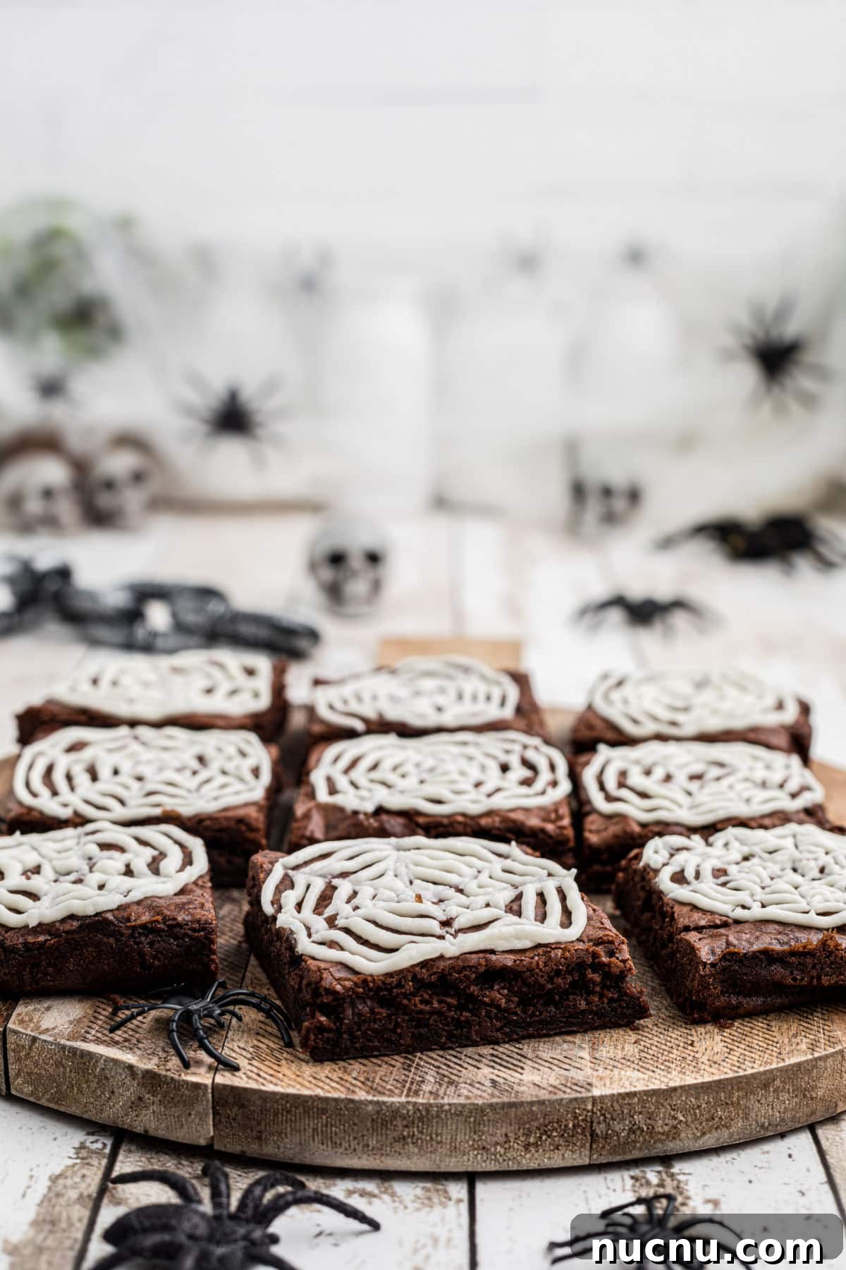 Spider Web Brownies: How to Make Spooky Halloween Brownies Quickly 5 Side view of a board with brownies surrounded by spiders.