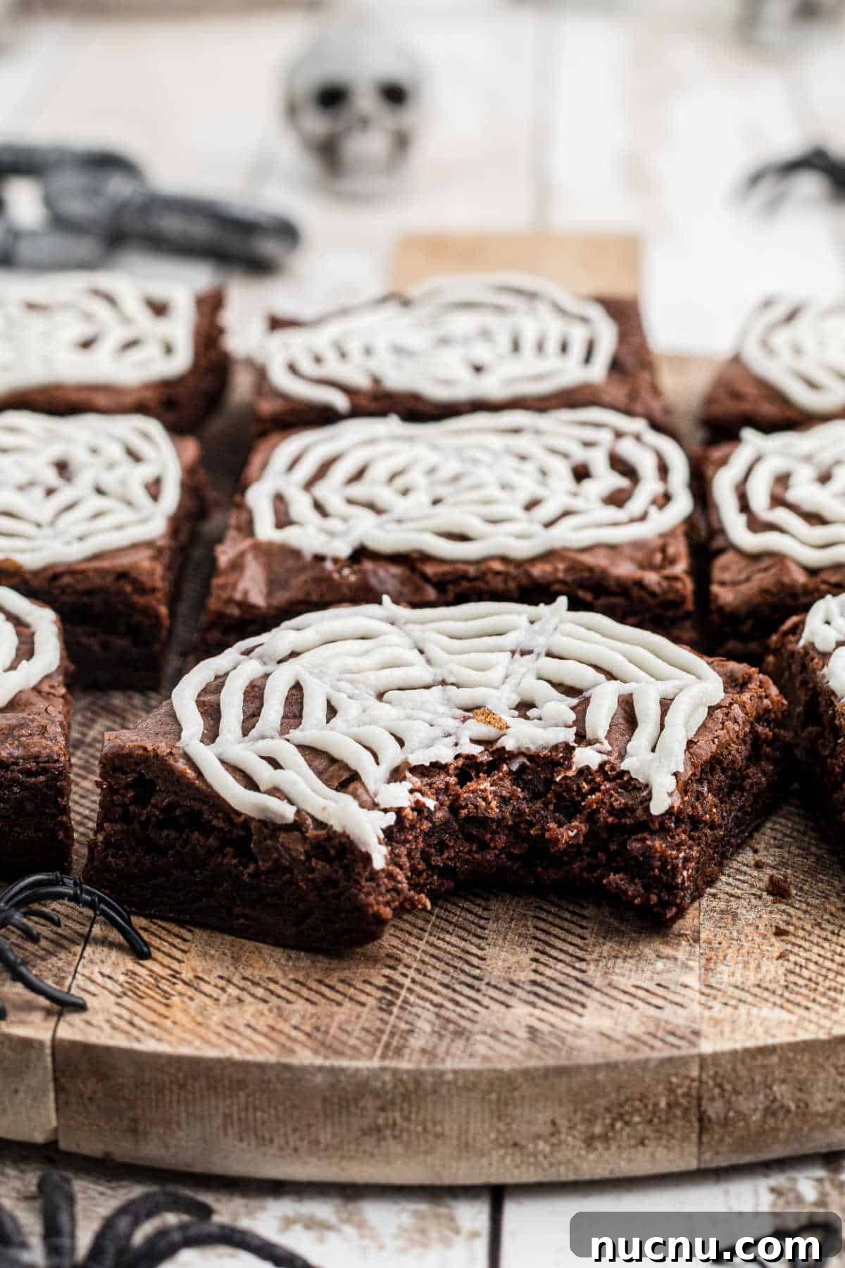 Spider Web Brownies: How to Make Spooky Halloween Brownies Quickly 10 A spider web brownie with a bite taken out of it.