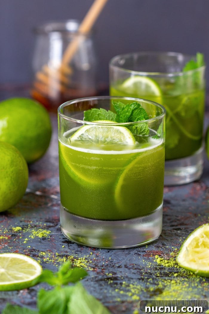 Chilled Matcha Iced Tea Recipe for Refreshing Green Tea Drinks 2 Glass of iced matcha tea with lime slices and fresh mint garnish.