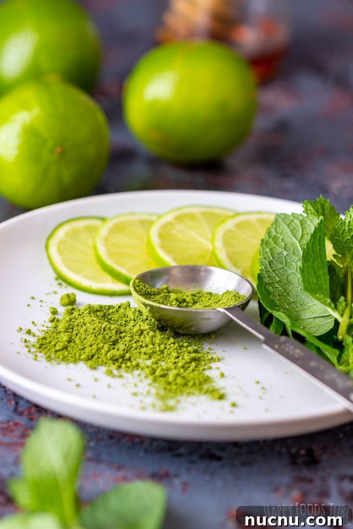 Chilled Matcha Iced Tea Recipe for Refreshing Green Tea Drinks 3 Matcha powder, fresh mint and sliced lime on a white plate.