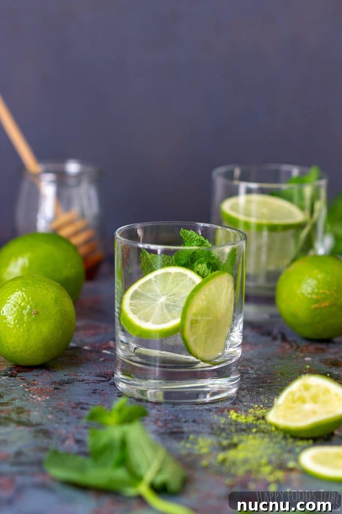 Chilled Matcha Iced Tea Recipe for Refreshing Green Tea Drinks 5 Empty glass prepared with lime slices and fresh mint leaves.