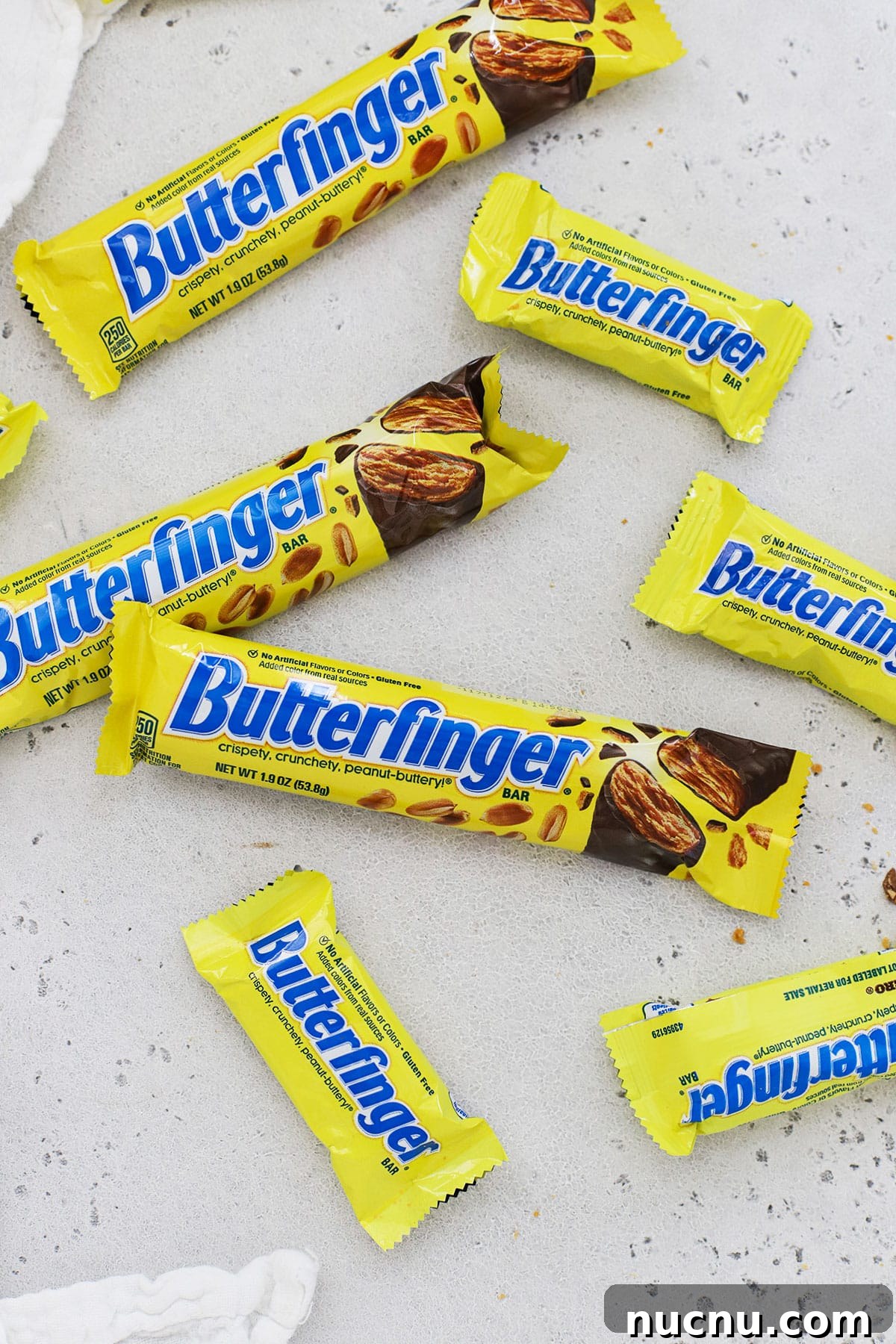 different sizes of Butterfinger candy bars on a white background