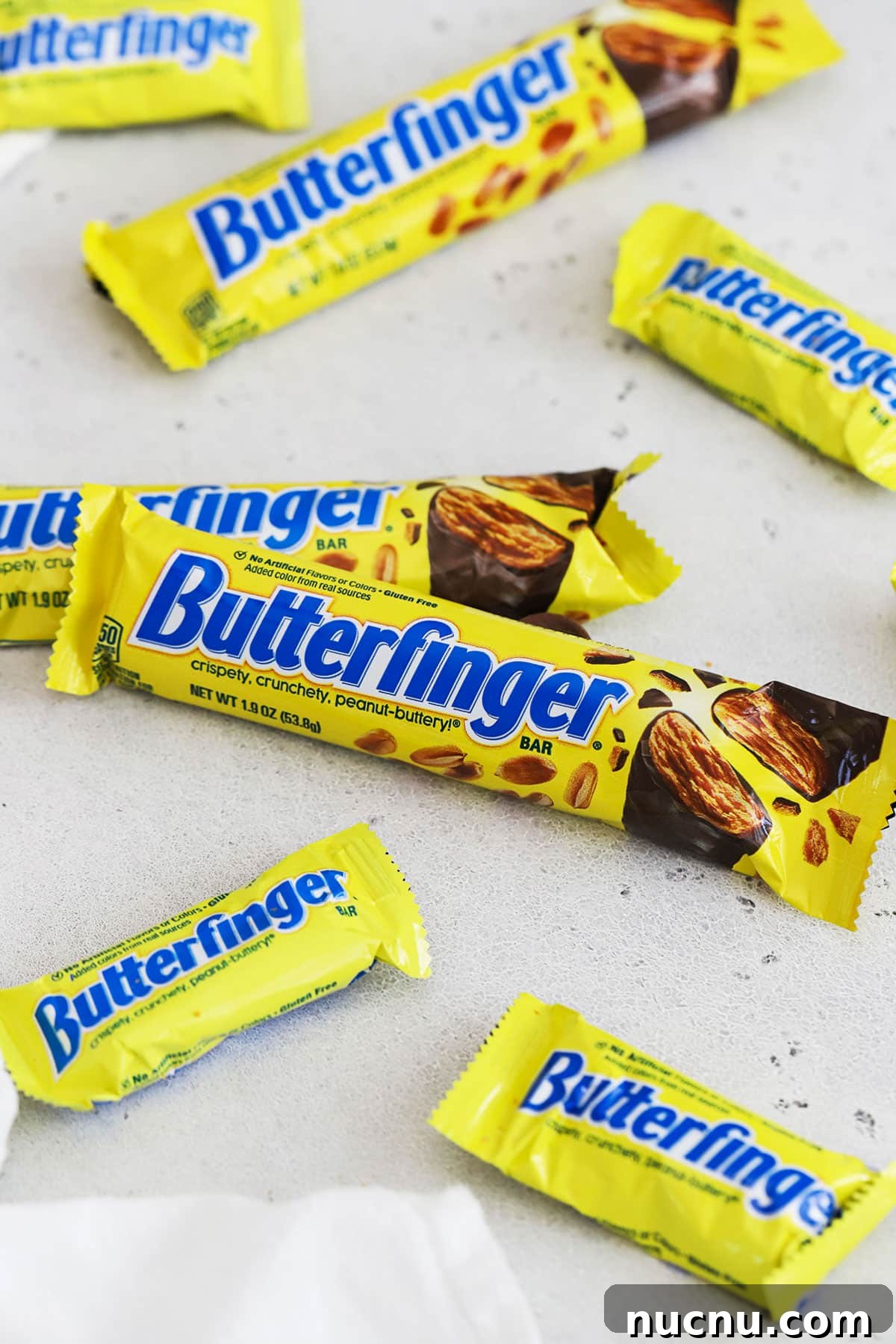 different sizes of Butterfinger candy bars on a white background