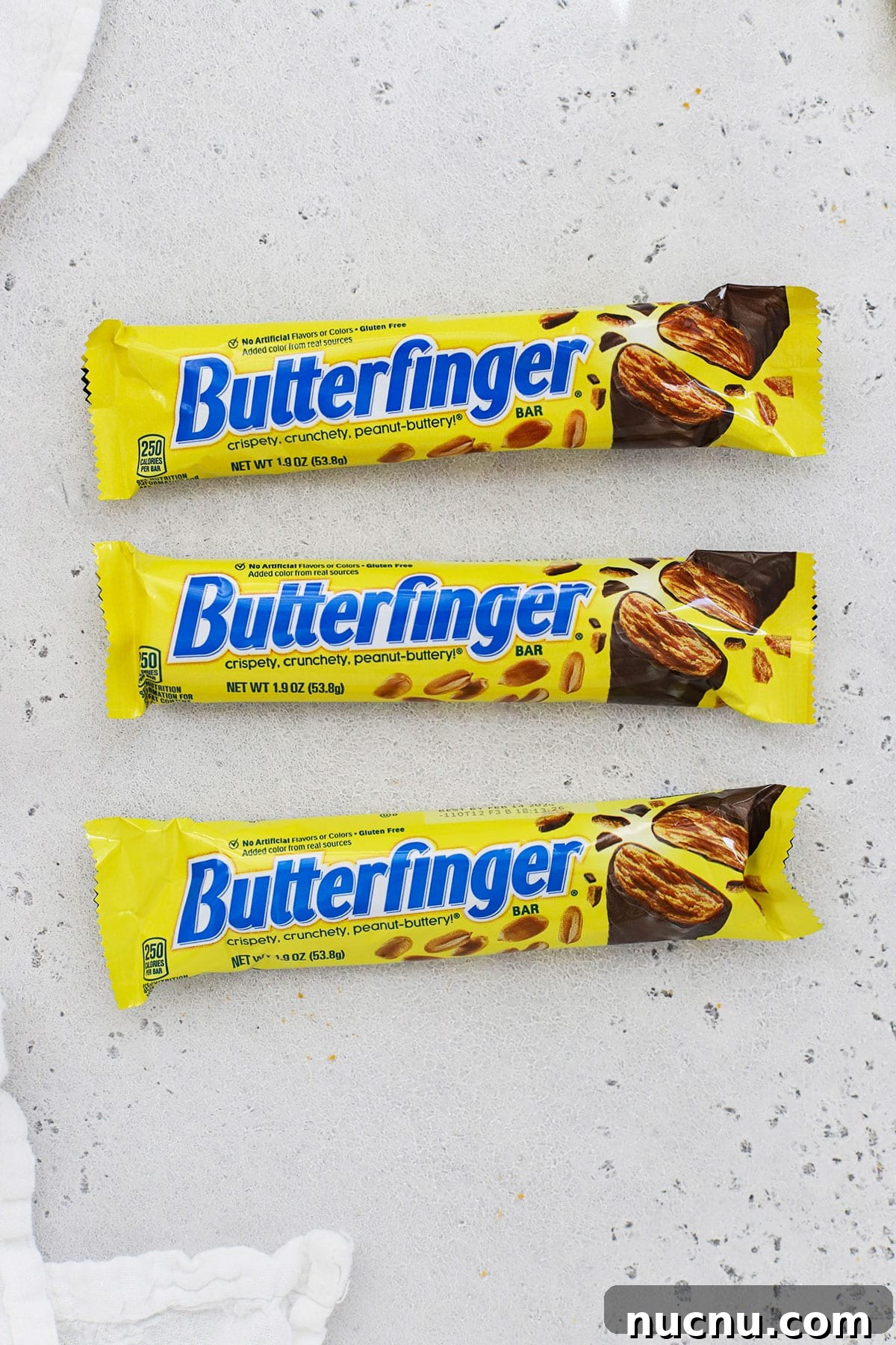 three sizes of Butterfinger candy bars on a white background