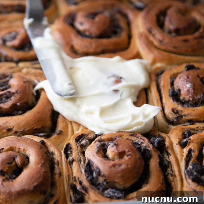 Cookies and Cream Roll Recipe: Decadent No-Bake Dessert 12 spread cream cheese frosting over baked rolls.