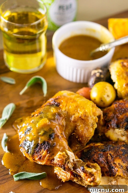 Spatchcock Chicken Roasted with Apple Cider Glaze 6 A piece of chicken leg and thigh of a roasted apple cider spatchcock chicken, apple cider gravy on side.
