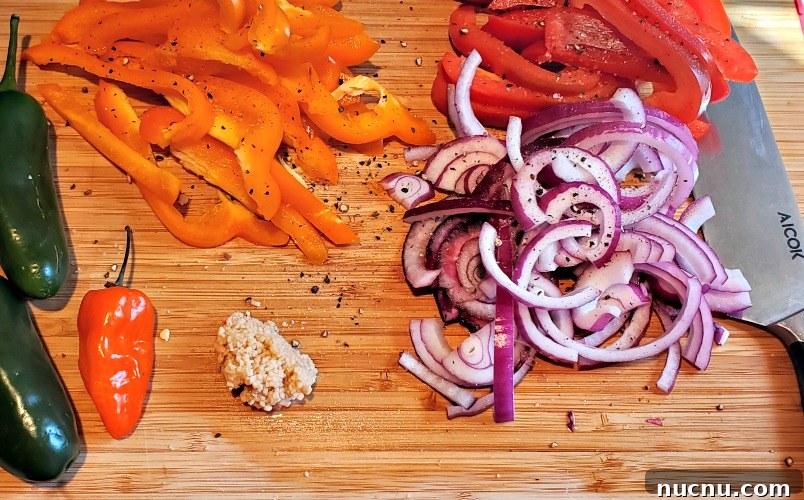 Blackstone Griddle Shrimp Fajitas Recipe — Juicy Sizzling Skillet Meal 4 Vegetables for fajitas sliced on a cutting board with a knife